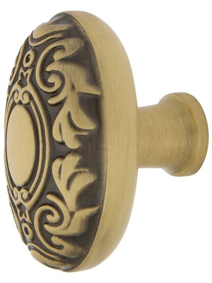 Decorative Oval Cabinet Knob - 1 1/8 inch x 1 3/4 inch in Antique Brass.